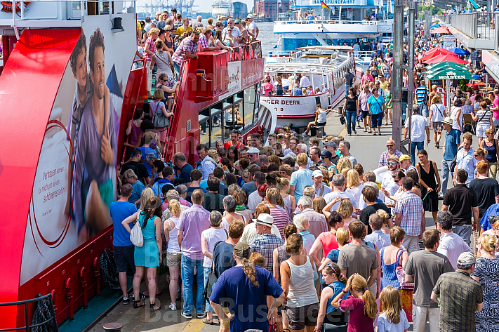 Menschenmenge drängt an den Hamburger Landungsbrücken auf eine Hafenfähre