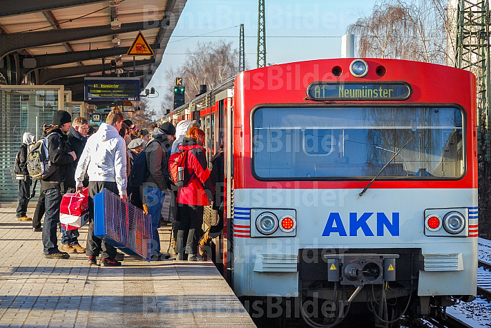 Menschen steigen in AKN-Triebwagen im S-Bahnhof Eidelstedt