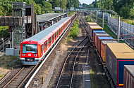 Eine Hamburger S-Bahn und ein Güterzug (Güterumgehungsbahn) treffen sich an der Haltestelle Rübenkamp