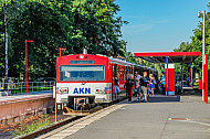 Menschen steigen aus einem AKN-Triebwagen am Haltepunkt Burgwedel in Hamburg