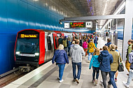 Menschen steigen in einen Zug der Linie U4 in der Haltestelle Überseequartier in Hamburg